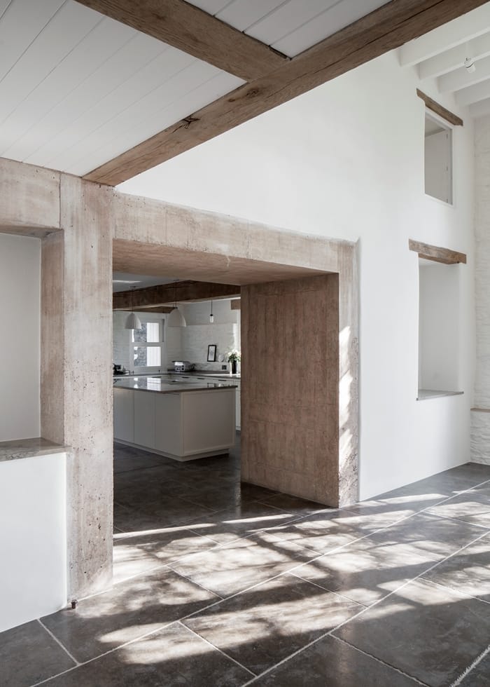 Coastal House view into kitchen, slate floor, imposing stone doorway, exposed beams, RIBA Awards 2018