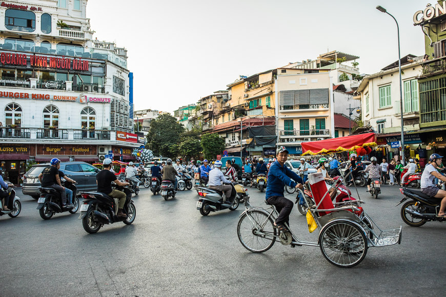 Vietnam, Hanoi, Old Quarter, busy city with motorbikes and cycle rickshaw