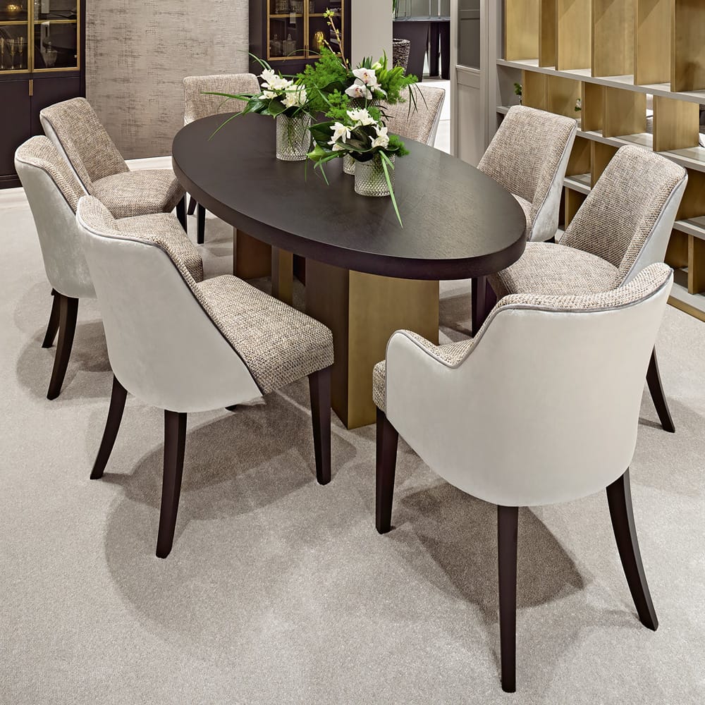 Statement Furniture, dark wood oval dining table with 8 ivory upholstered chairs