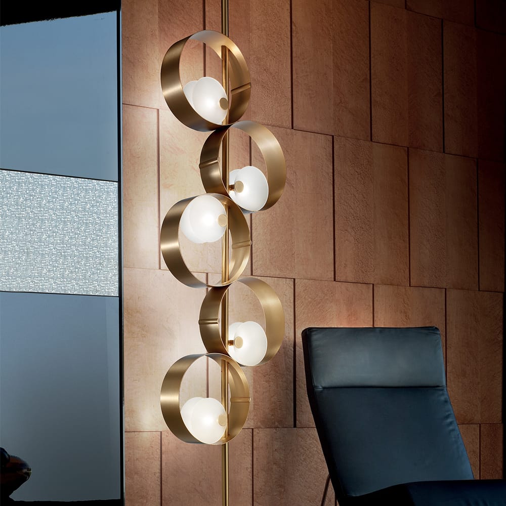 impress the guests, floor to ceiling light, 5 gold circles suspended in line, each with off-centre light within