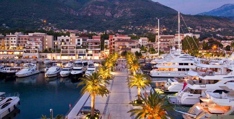 Porto Montenegro Marina with luxury yachts and superyachts, hotels and mountains in the background