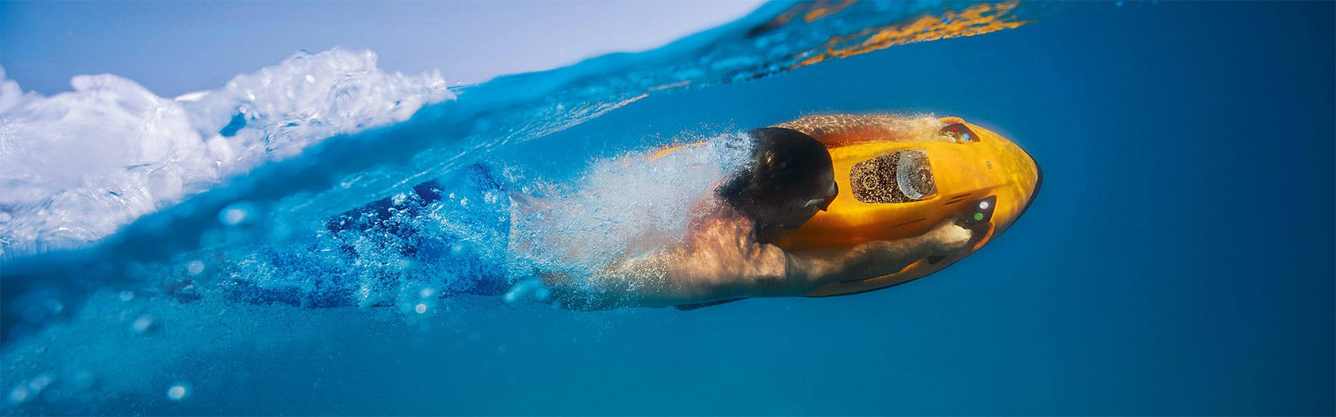 Person diving under water with a yellow Seabob, yacht toys