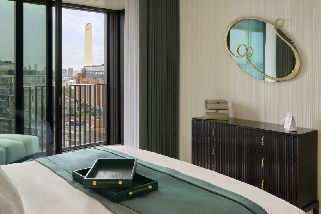 Luxury bedroom and ornate mirror in luxury apartment overlooking Battersea power station in London interior designed by Juliettes Interiors