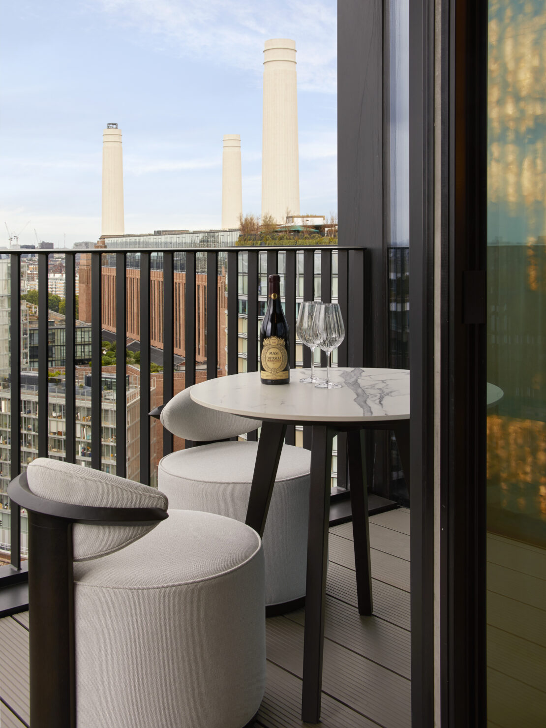 Balcony over looking Battersea power station in luxury London apartment designed by Juliettes Interiors