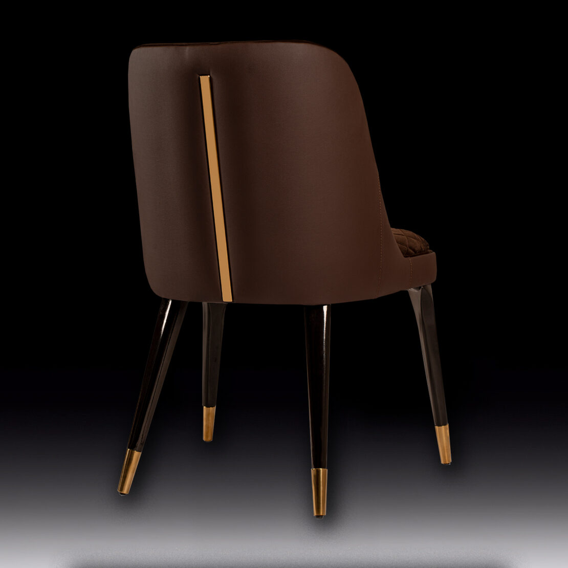 The Exclusive Modern Quilted Dining Chair boasts a brown upholstered seat with a sleek design, featuring a golden metal accent running vertically down the back. The chair stands on four black legs with golden tips, and the solid black background accentuates its elegant and contemporary aesthetic.